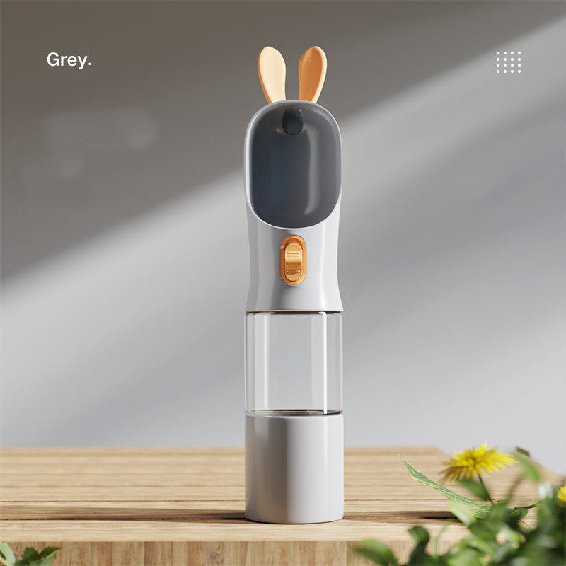 Pet water travel bottle in grey; clear chamber with dark grey bottom