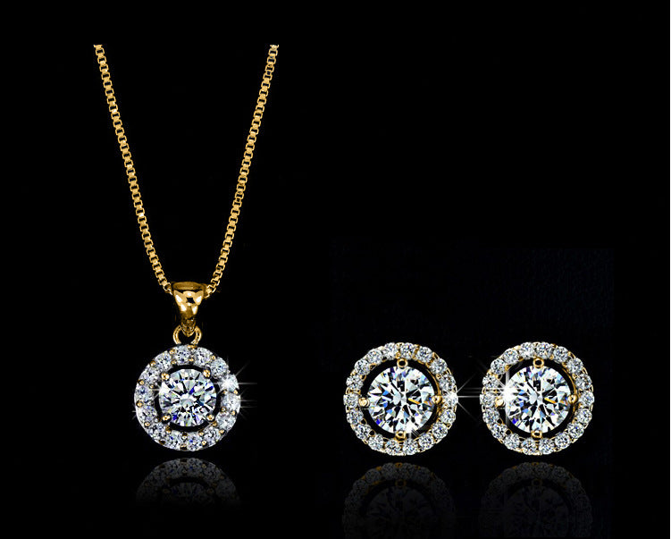 Gold jewelry set with round pendant necklace and two matching stud earrings