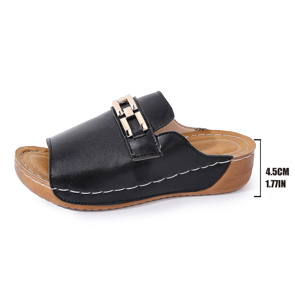 Black peep-toe wedge mules with gold metal buckle and stitched platform sole