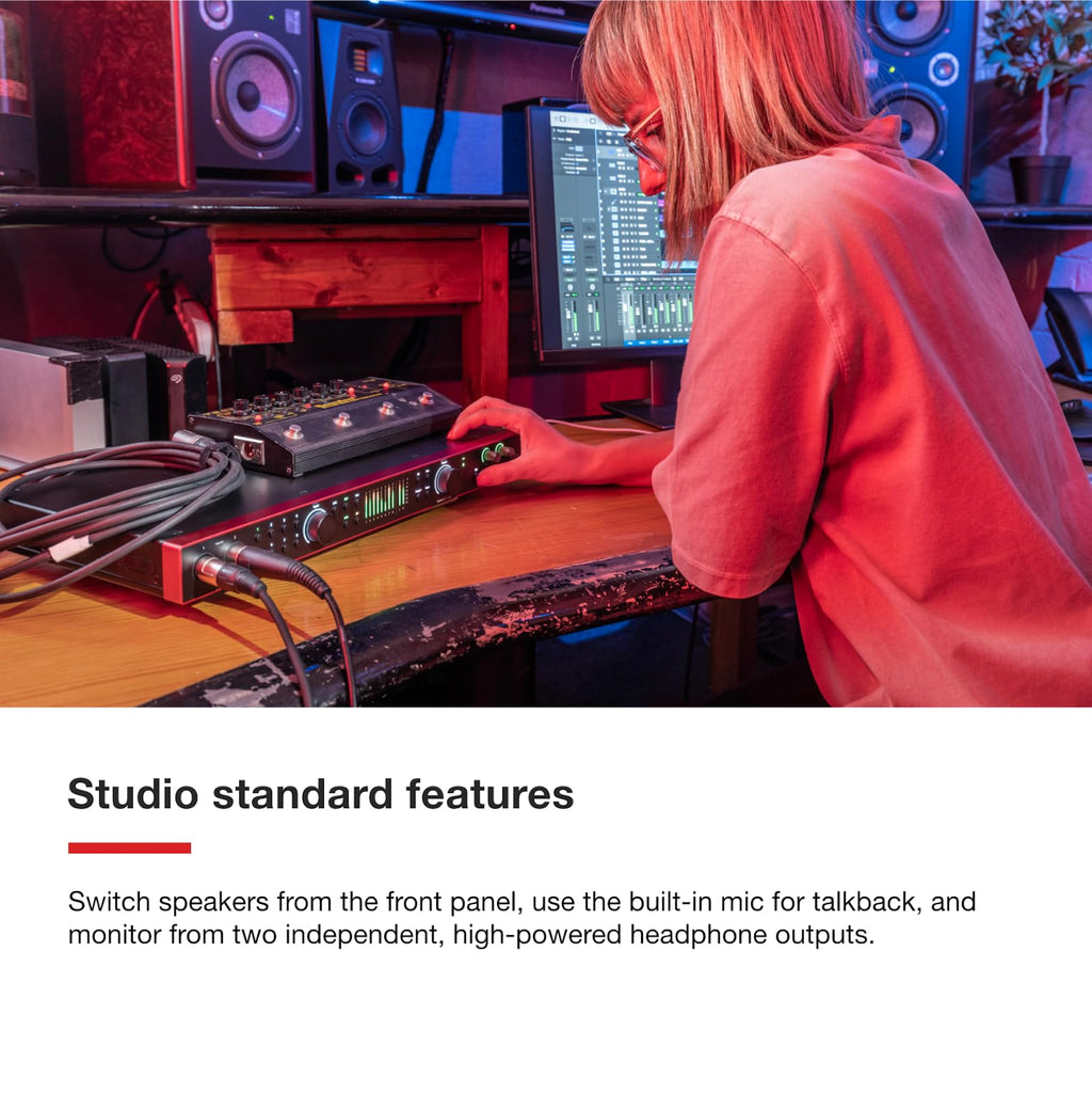 Red Focusrite Scarlett 18i16 USB audio interface on desk with connected cables