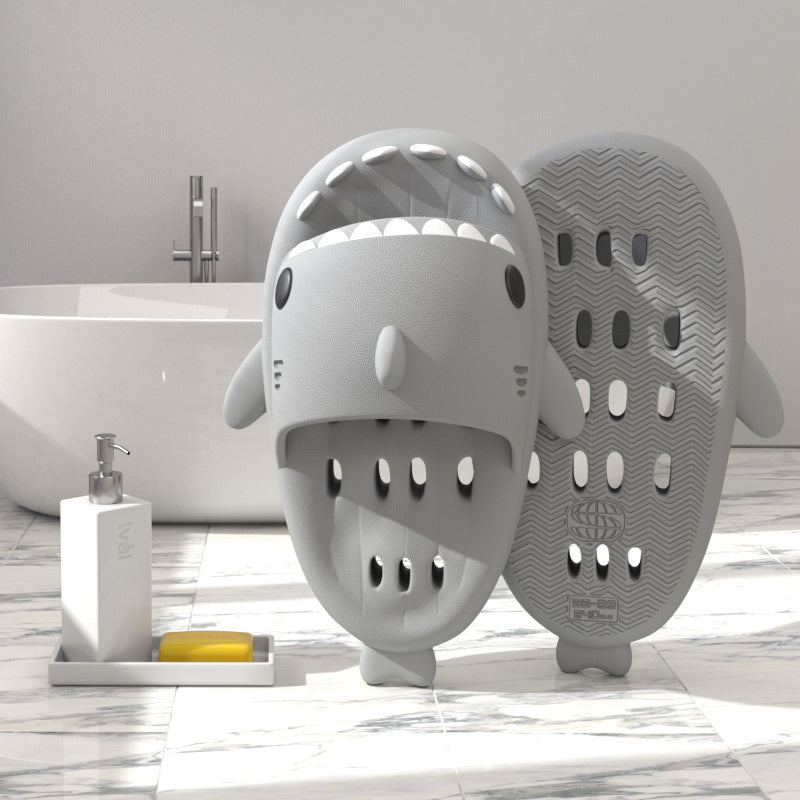 Light gray shark-shaped EVA shower slide with drainage holes and textured sole