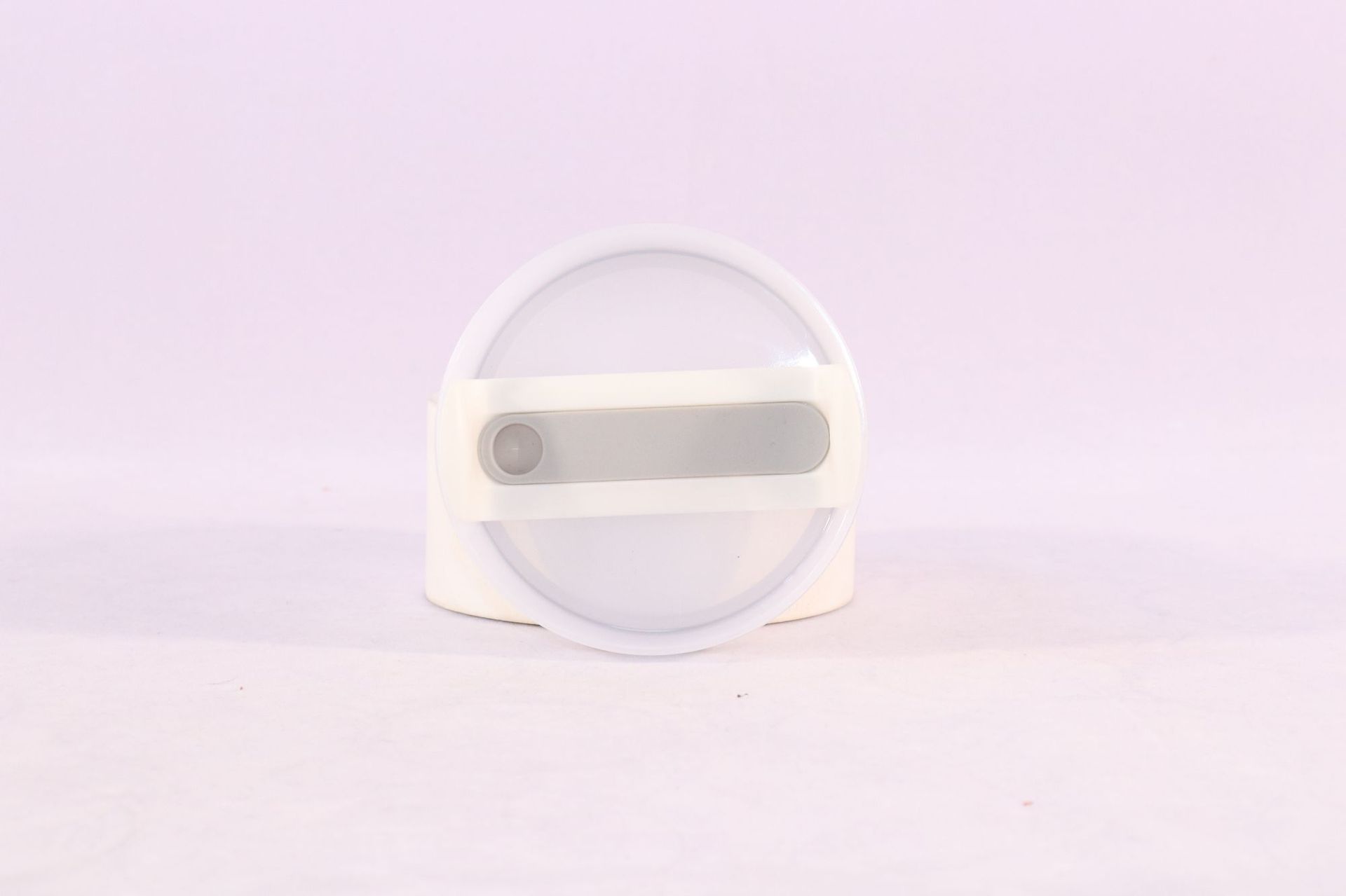 Tumbler lid with straw opening and gray slider, translucent top disc.
