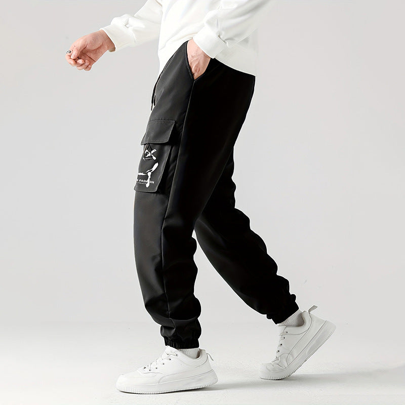 Black cargo jogger pants with utility side pockets and tied drawstring hem