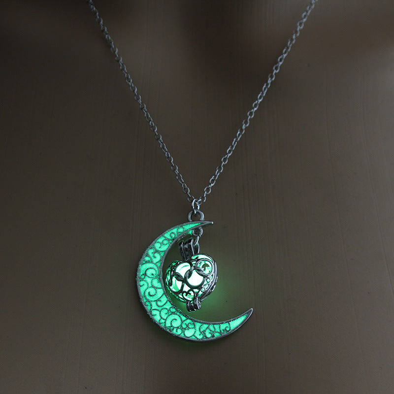 Glowing green moon pendant necklace with cat lantern charm on silver chain