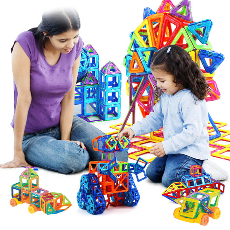 Magnetic building blocks play set with colorful castle pieces and small vehicles